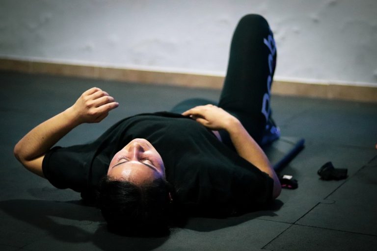 crossfitter laying on the ground tired rocket city performance therapy
